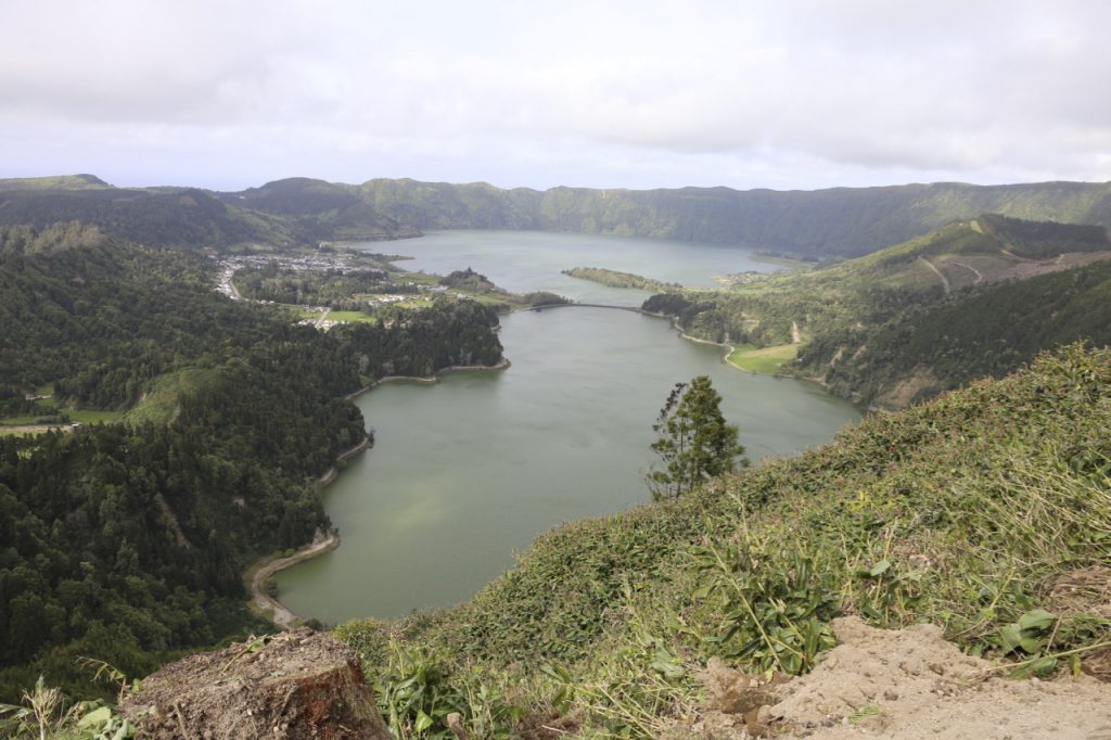 Lagoa das Sete Cidades is a twin lake situated in the crater of a dormant volcano on the Portuguese archipelago of the Azores. It consists of two small, ecologically different lakes connected by a narrow strait, which is crossed by a bridge.