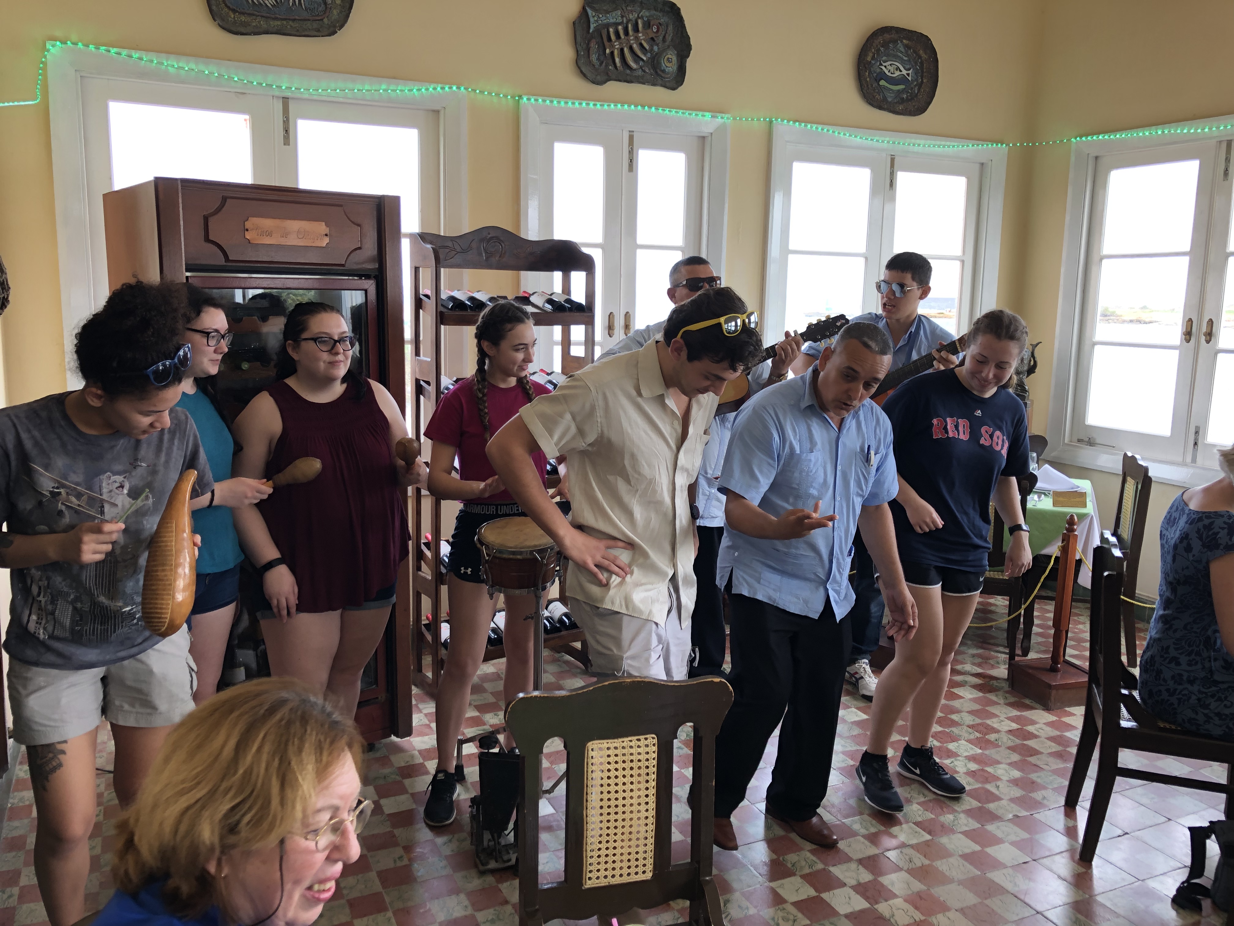 Honors students play instruments and are guided by a musician in how to dance salsa at the restaurant La Terrazza de Cojimar.