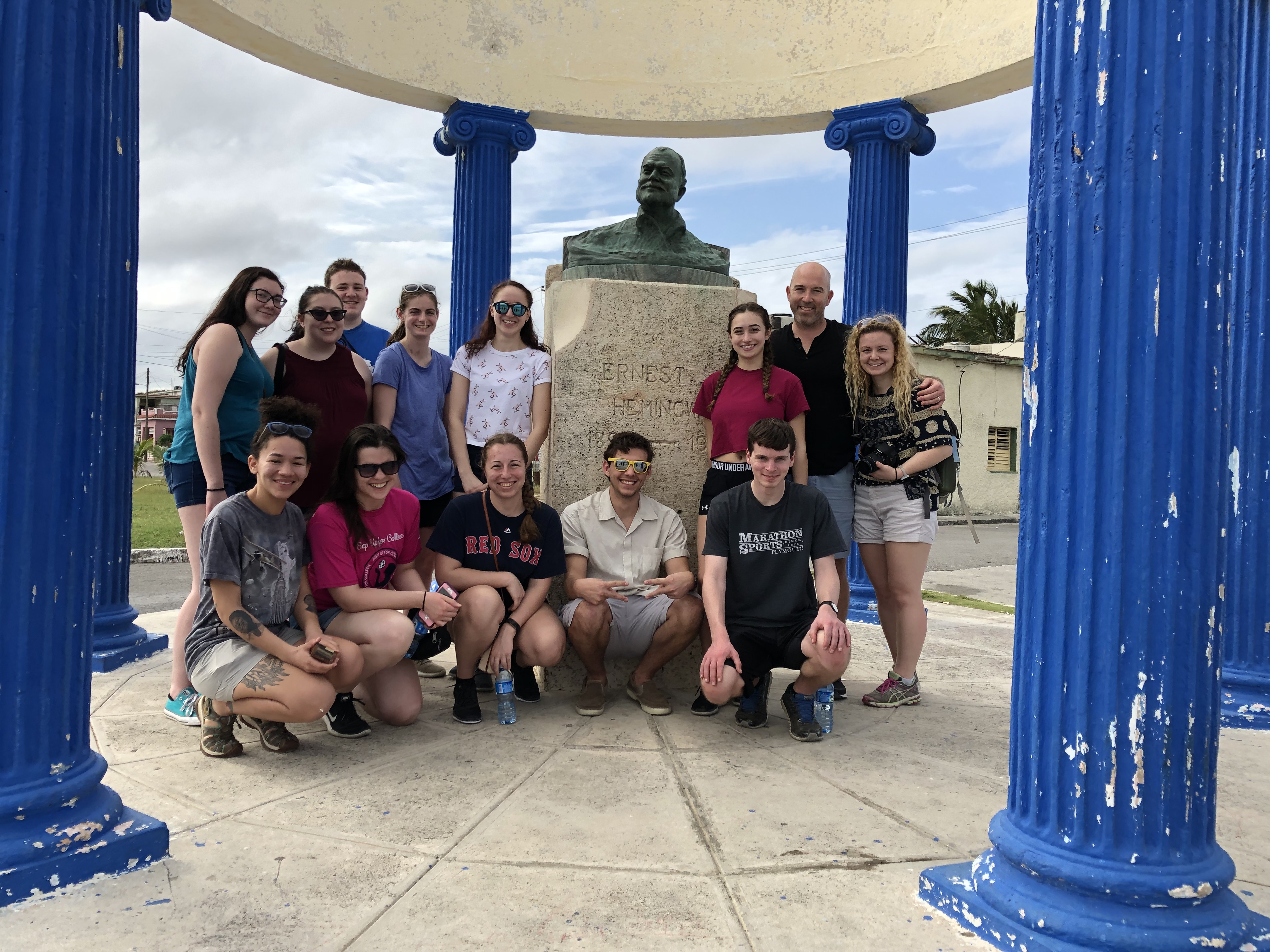 Honors students stand before a bust of Ernest Hemingway in the fishing town of Cojimar. It was the first bust of Hemingway in the world, constructed by the region's fishermen not long after Hemingway's death.