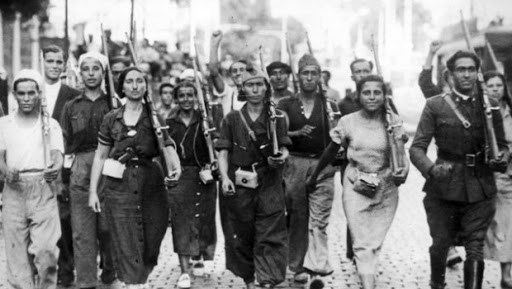 A group of female soldiers face the camera with rifles over their shoulders.