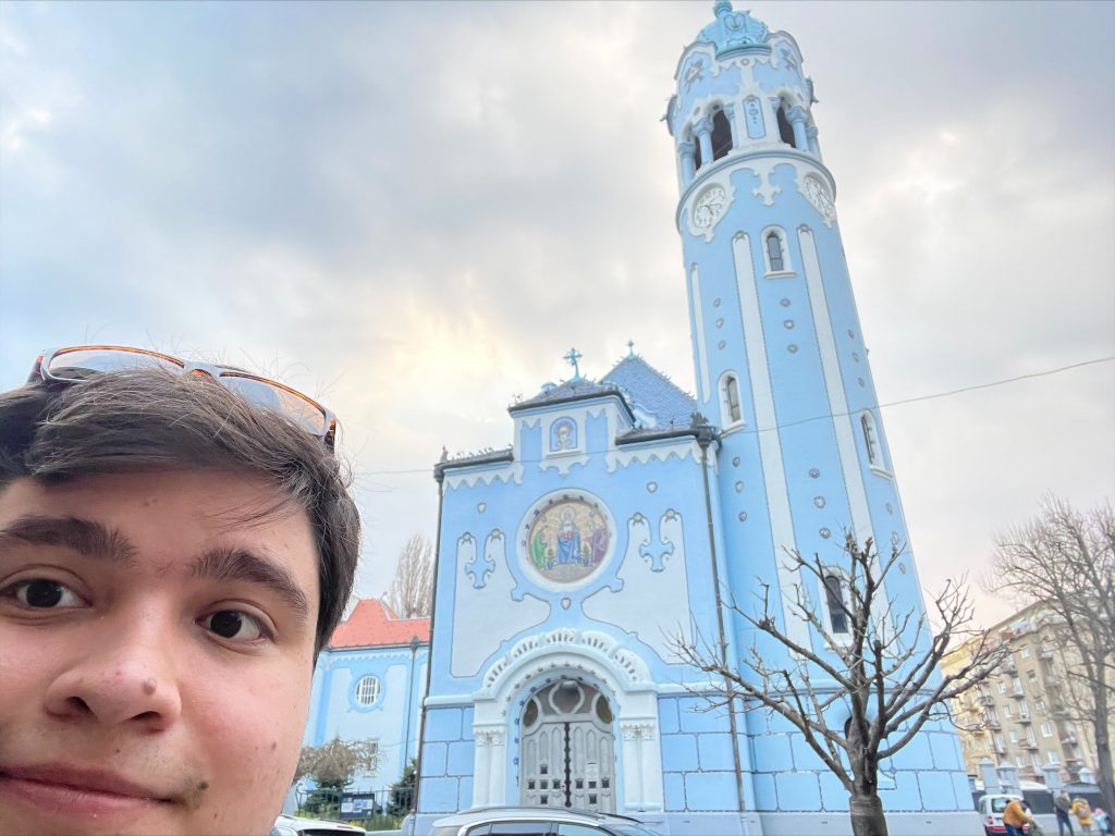 Stefan Iglesias with church in modena italy in background