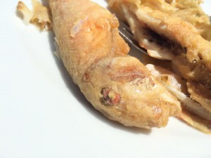 A closeup of a salmon's head from a seafood pinxtos restaurant
